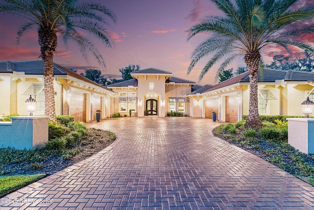 120 Hallowes Cv, Saint Johns, FL 32259 - mediterranean / spanish-style home with an attached garage, decorative driveway, stucco siding, and french doors