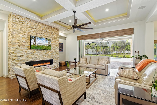 120 Hallowes Cv, Saint Johns, FL 32259 - living area with a fireplace, wood finished floors, a ceiling fan, beam ceiling, and coffered ceiling