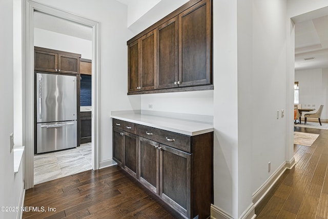 120 Hallowes Cv, Saint Johns, FL 32259 - kitchen featuring freestanding refrigerator, dark brown cabinetry, and hardwood / wood-style flooring