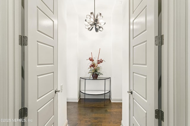 120 Hallowes Cv, Saint Johns, FL 32259 - corridor with a chandelier, dark wood finished floors, and baseboards