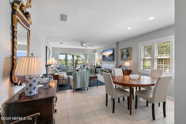 91 San Juan Dr Unit H8, Ponte Vedra Beach, FL 32082 - dining space with healthy amount of natural light, a ceiling fan, recessed lighting, light tile patterned flooring, and a glass covered fireplace