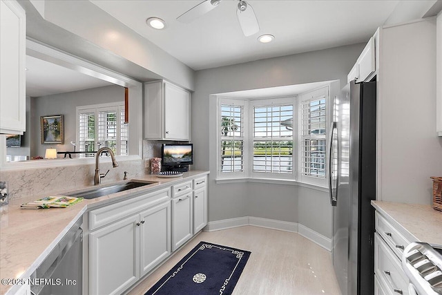 91 San Juan Dr Unit H8, Ponte Vedra Beach, FL 32082 - kitchen featuring a sink, stainless steel appliances, ceiling fan, light wood-style floors, and white cabinets