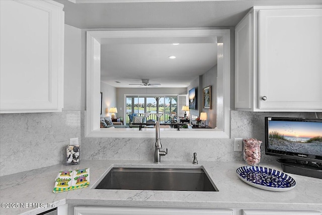 91 San Juan Dr Unit H8, Ponte Vedra Beach, FL 32082 - kitchen with a sink, ceiling fan, tasteful backsplash, and white cabinetry