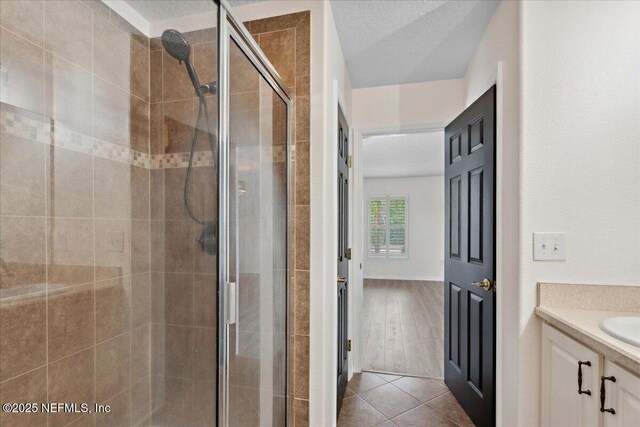 3357 Pegaso Ave, New Smyrna Beach, FL 32168 - bathroom with a shower stall, vanity, and tile patterned flooring