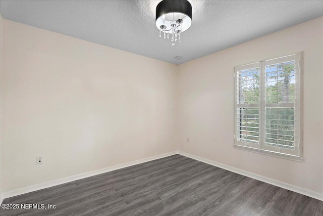 3357 Pegaso Ave, New Smyrna Beach, FL 32168 - spare room with dark wood-style floors, baseboards, and a textured ceiling