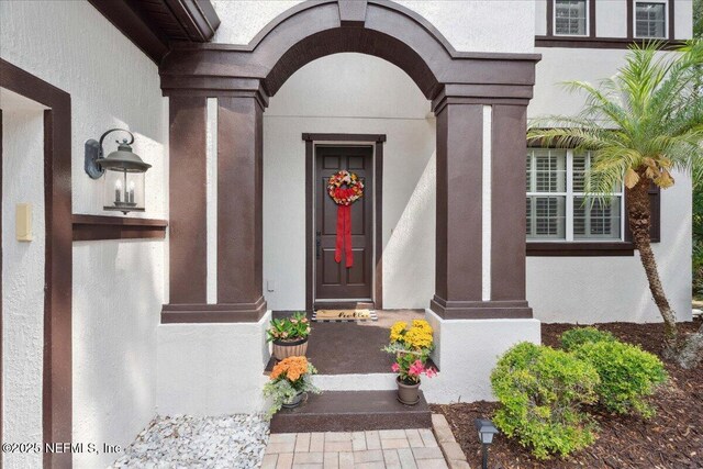 3357 Pegaso Ave, New Smyrna Beach, FL 32168 - view of exterior entry featuring stucco siding