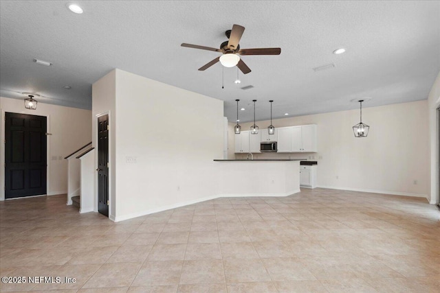 3357 Pegaso Ave, New Smyrna Beach, FL 32168 - unfurnished living room featuring ceiling fan, baseboards, recessed lighting, a textured ceiling, and light tile patterned floors