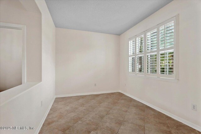 3357 Pegaso Ave, New Smyrna Beach, FL 32168 - unfurnished room featuring a textured ceiling and baseboards