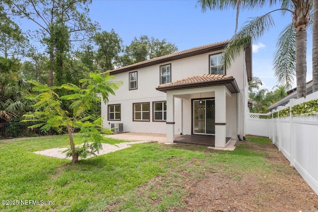 3357 Pegaso Ave, New Smyrna Beach, FL 32168 - back of house with a tile roof, a patio area, stucco siding, and central air condition unit