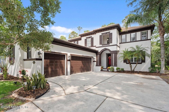 3357 Pegaso Ave, New Smyrna Beach, FL 32168 - mediterranean / spanish-style house featuring concrete driveway, an attached garage, stucco siding, and a tile roof