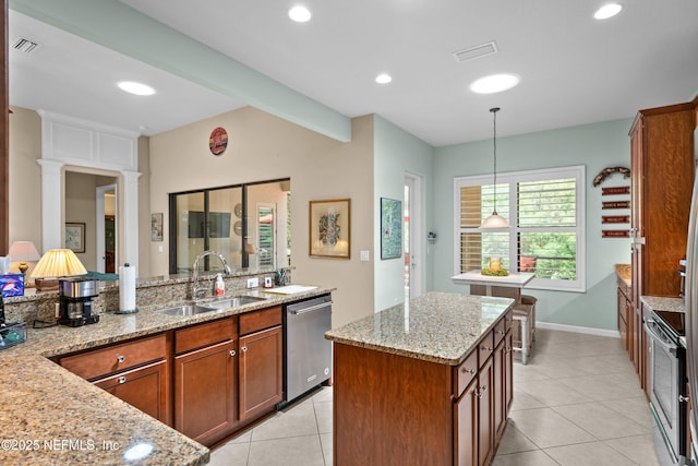90 Canopy Glades Cir, Ponte Vedra, FL 32081 - kitchen featuring a sink, stainless steel appliances, brown cabinets, light tile patterned floors, and light stone counters