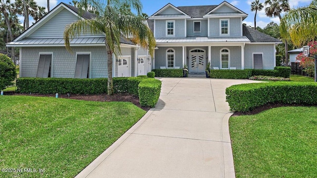 231 N Roscoe Blvd, Ponte Vedra Beach, FL 32082 - view of front of house featuring concrete driveway, an attached garage, a front lawn, and covered porch
