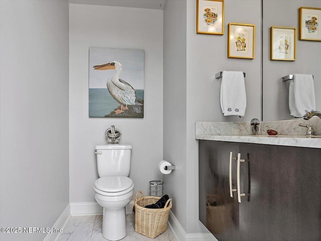 231 N Roscoe Blvd, Ponte Vedra Beach, FL 32082 - bathroom featuring baseboards, toilet, marble look tile flooring, and vanity