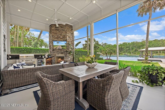231 N Roscoe Blvd, Ponte Vedra Beach, FL 32082 - sunroom / solarium featuring an outdoor stone fireplace, a ceiling fan, a water view, and exterior kitchen
