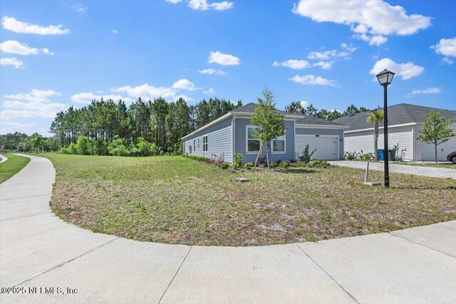 view of home's exterior featuring a yard, driveway, and a garage