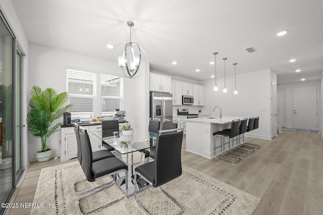 75556 Canterwood Dr, Yulee, FL 32097 - dining space with light wood finished floors, recessed lighting, and a chandelier