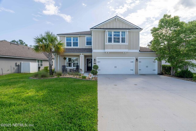 2565 Cold Stream Ln, Green Cove Springs, FL 32043 - craftsman-style home with driveway, a front yard, a garage, and board and batten siding