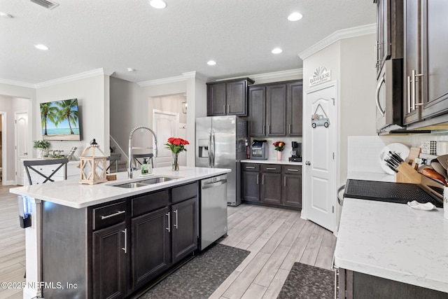 2565 Cold Stream Ln, Green Cove Springs, FL 32043 - kitchen featuring appliances with stainless steel finishes, a sink, ornamental molding, a kitchen island with sink, and recessed lighting