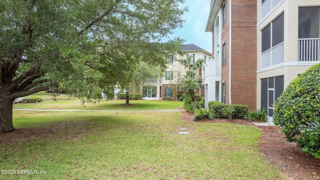 view of property's community with a lawn