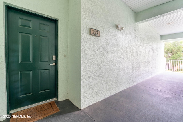 doorway to property with stucco siding