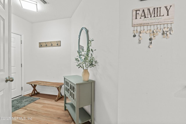 doorway to outside featuring light wood-style floors and baseboards