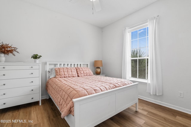 bedroom featuring wood finished floors, baseboards, and ceiling fan