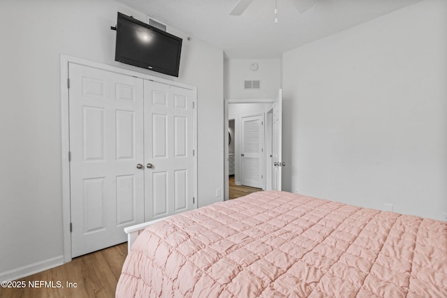 bedroom featuring wood finished floors, a closet, and ceiling fan