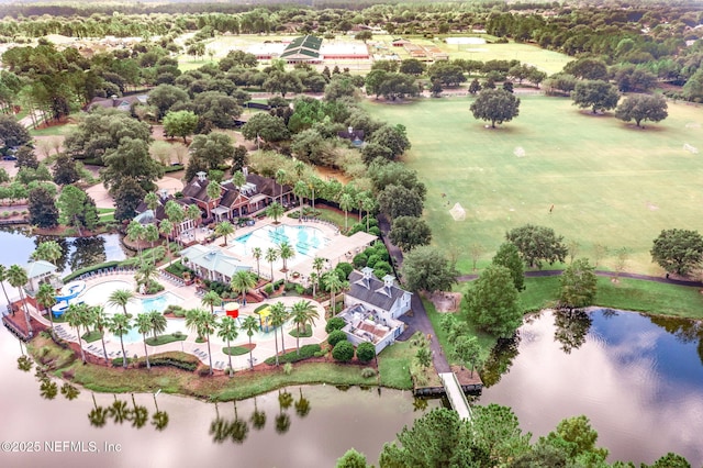 aerial view of a pool area and a nearby body of water