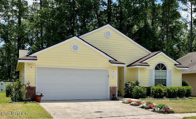 9536 Glenn Abbey Way, Jacksonville, FL 32256 - single story home featuring concrete driveway, a garage, a chimney, and brick siding