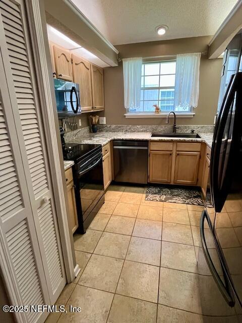 9536 Glenn Abbey Way, Jacksonville, FL 32256 - kitchen with black appliances, a sink, light tile patterned flooring, light stone countertops, and a textured ceiling