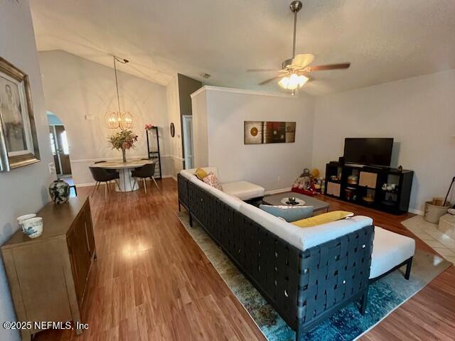 9536 Glenn Abbey Way, Jacksonville, FL 32256 - living area with wood finished floors, a ceiling fan, a chandelier, and lofted ceiling