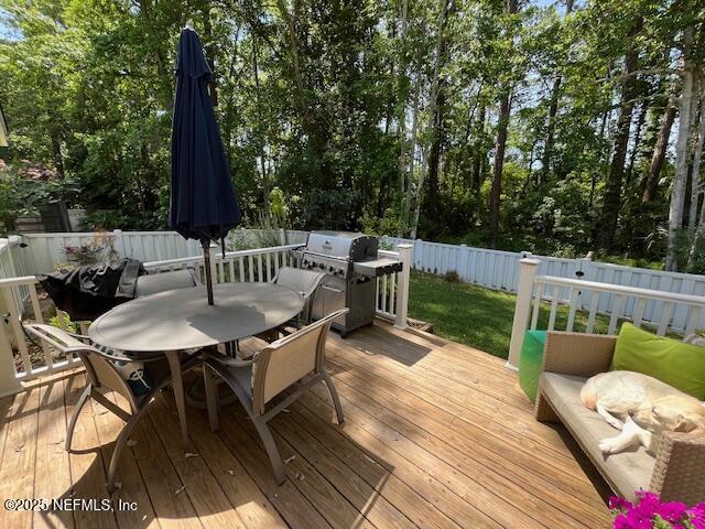 9536 Glenn Abbey Way, Jacksonville, FL 32256 - wooden terrace with outdoor dining space, a fenced backyard, and grilling area