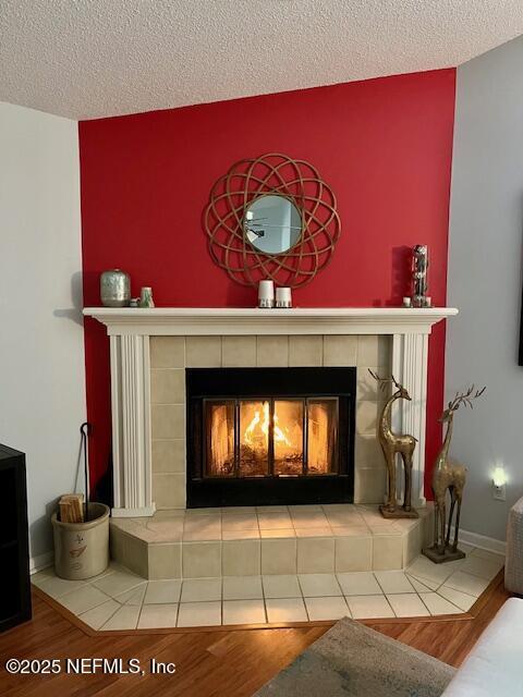 9536 Glenn Abbey Way, Jacksonville, FL 32256 - detailed view of a tile fireplace, wood finished floors, and a textured ceiling