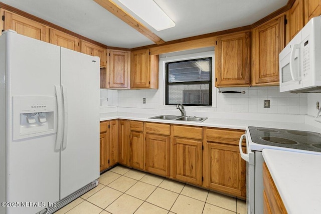 kitchen with white appliances, a sink, backsplash, and light countertops