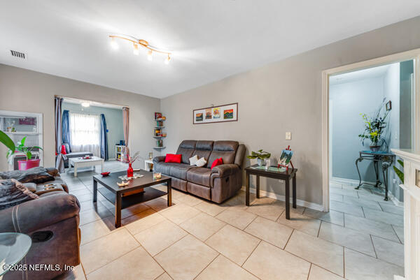 2760 Jerry Ln, Jacksonville, FL 32218 - living room featuring light tile patterned floors and baseboards