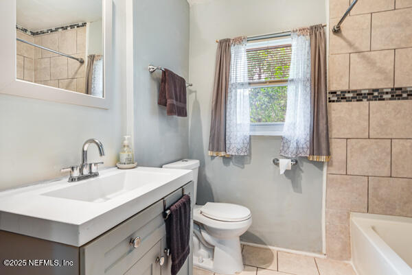 2760 Jerry Ln, Jacksonville, FL 32218 - bathroom with tile patterned flooring, toilet, vanity, and shower / washtub combination