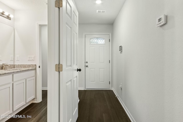 8468 Buttercup St, Jacksonville, FL 32210 - doorway to outside with a sink, dark wood-type flooring, and baseboards