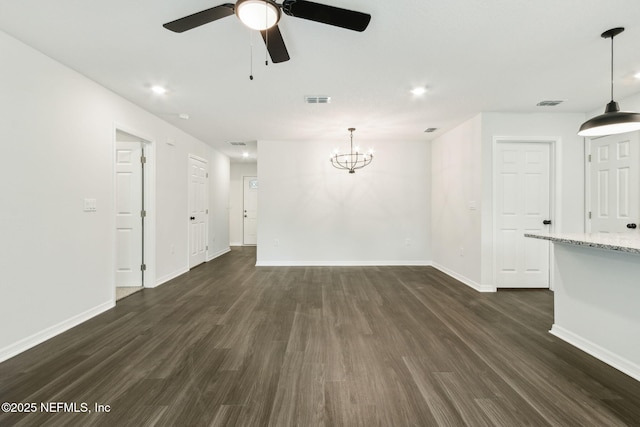 8468 Buttercup St, Jacksonville, FL 32210 - unfurnished living room featuring dark wood-style flooring, baseboards, a ceiling fan, a chandelier, and recessed lighting