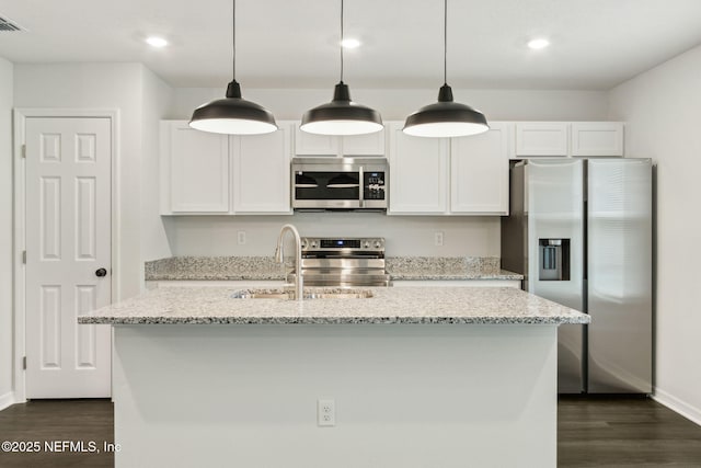 8468 Buttercup St, Jacksonville, FL 32210 - kitchen featuring appliances with stainless steel finishes, dark wood finished floors, a sink, baseboards, and white cabinets