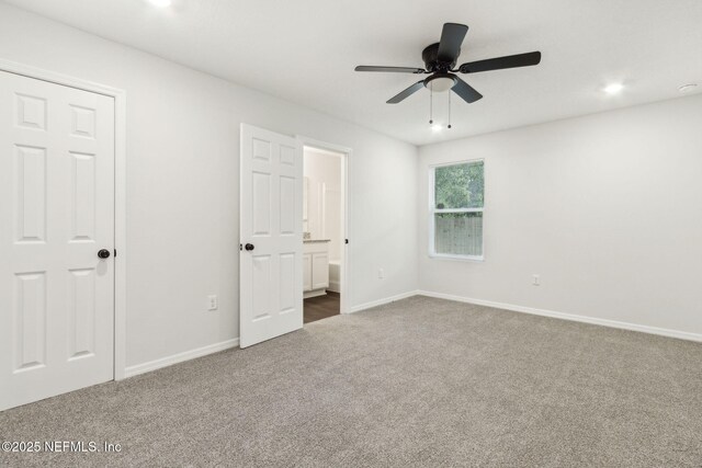 8468 Buttercup St, Jacksonville, FL 32210 - unfurnished bedroom featuring dark carpet, baseboards, ensuite bath, a ceiling fan, and recessed lighting