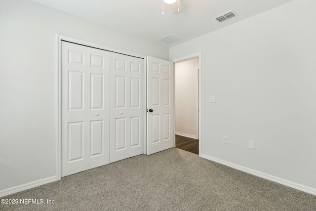 8468 Buttercup St, Jacksonville, FL 32210 - unfurnished bedroom featuring dark carpet, a closet, baseboards, and a ceiling fan