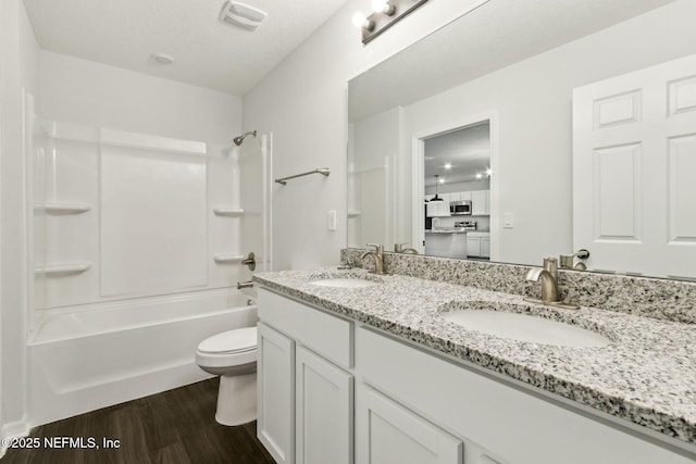 8468 Buttercup St, Jacksonville, FL 32210 - bathroom with wood finished floors, toilet, double vanity, and bathing tub / shower combination