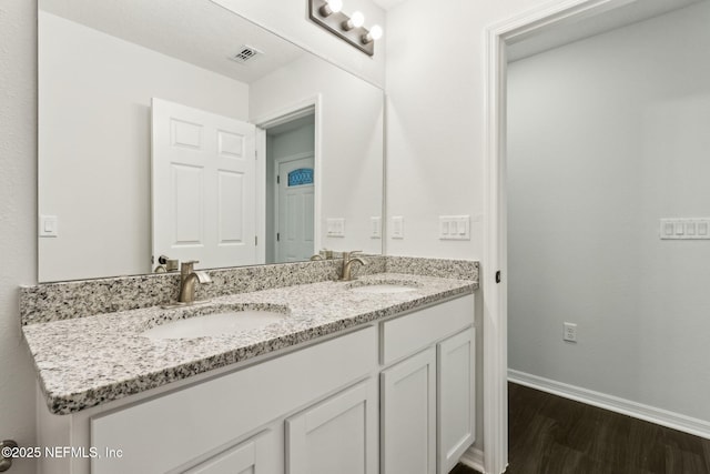 8468 Buttercup St, Jacksonville, FL 32210 - full bathroom with double vanity, wood finished floors, and baseboards
