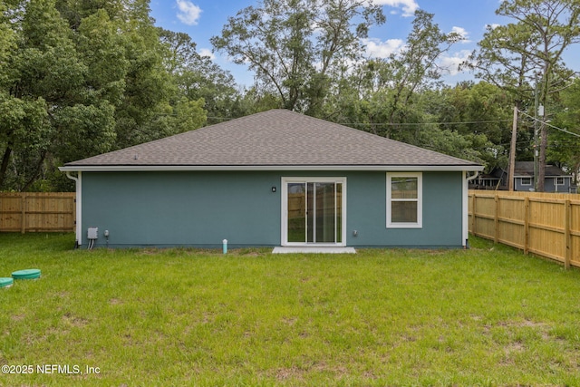 8468 Buttercup St, Jacksonville, FL 32210 - rear view of house with a shingled roof and stucco siding