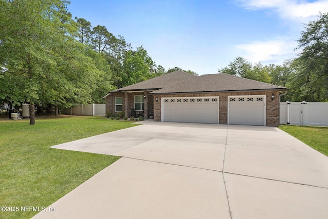 1309 Foxmeadow Trl, Middleburg, FL 32068 - view of front of home with driveway, an attached garage, brick siding, a gate, and roof with shingles