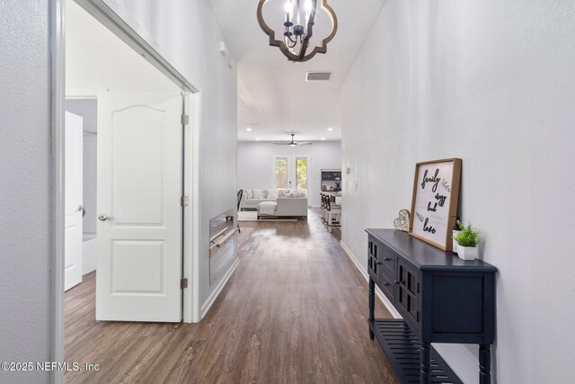 1309 Foxmeadow Trl, Middleburg, FL 32068 - corridor with wood finished floors, a chandelier, and baseboards