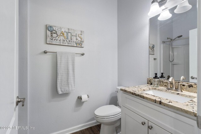 1309 Foxmeadow Trl, Middleburg, FL 32068 - bathroom featuring vanity, toilet, wood finished floors, a shower, and baseboards