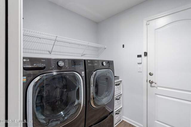 1309 Foxmeadow Trl, Middleburg, FL 32068 - washroom with washer and clothes dryer, wood finished floors, and baseboards
