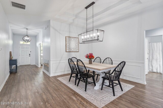1309 Foxmeadow Trl, Middleburg, FL 32068 - dining room featuring a chandelier, dark wood-style floors, a decorative wall, wainscoting, and baseboards