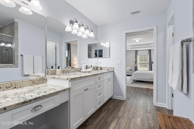 1309 Foxmeadow Trl, Middleburg, FL 32068 - full bath featuring wood finished floors, double vanity, baseboards, ensuite bath, and a shower with shower door